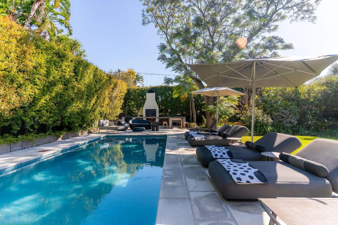 Paloma Villa and its pool at dusk, steps from Franschhoek's main street