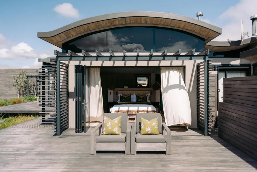 A bedroom with decked terrace at Perivoli Lagoon House